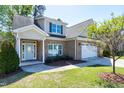 Attractive brick home with a manicured lawn, colorful shrubbery, and two-car garage at 837 Varina Ln, Fuquay Varina, NC 27526