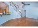 Bright living room featuring hardwood floors, a high ceiling, and staircase at 906 Ingram Ct, Hillsborough, NC 27278