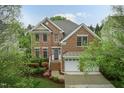 Charming brick two-story home featuring an attached two-car garage and manicured landscaping at 9225 Palm Bay Cir, Raleigh, NC 27617