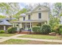 Inviting two-story home with a classic front porch and lush greenery enhancing curb appeal at 1005 W Lenoir St, Raleigh, NC 27603
