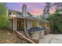 Striking home with a chimney and attached two car garage at dusk at 1011 Wood Sage Dr, Chapel Hill, NC 27516