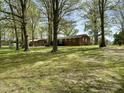 Expansive backyard featuring mature trees and a well-maintained lawn at 1031 Jackson Royster Rd, Henderson, NC 27537