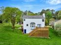 Backyard view of a two-story home with a large deck and spacious yard at 104 Dilworth Ct, Cary, NC 27513