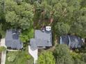Aerial view of the property, showcasing the home's location among mature trees, driveway, and backyard deck at 109 Deer Valley Dr, Cary, NC 27519
