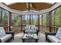 Inviting screened porch featuring comfortable seating and a serene view of the surrounding greenery at 109 Deer Valley Dr, Cary, NC 27519