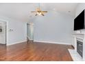 Spacious living room featuring hardwood floors and a cozy fireplace at 1101 Sky Wave Trl, Raleigh, NC 27603
