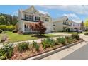 Beautifully landscaped front yard with flower beds leading up to a charming two-story home at 1127 Woodlands Creek Way, Apex, NC 27502
