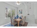 Bright dining area featuring stylish decor, a ceiling fan, and a window overlooking the outdoors at 113 Weatherhill Pt, Carrboro, NC 27510