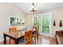 The dining room features a wooden table and chairs with a back door offering outdoor access and bright light at 13 Thorne Ridge Dr, Durham, NC 27713