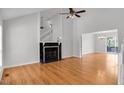 Bright living room features a fireplace, vaulted ceiling, and wood flooring at 1517 Laughridge Dr, Cary, NC 27511