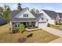 Charming home features a two-car garage, stone accents, covered porch and manicured landscaping at 158 Sea Foam Dr, Raleigh, NC 27610