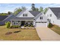 Charming home features a two-car garage, stone accents, covered porch and manicured landscaping at 158 Sea Foam Dr, Raleigh, NC 27610