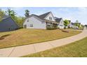 Side view of a charming home showcasing its well-maintained lawn and suburban street at 158 Sea Foam Dr, Raleigh, NC 27610