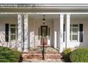 Inviting front porch with stately columns, offering a glimpse of the home's architectural charm and curb appeal at 1601 Dairyland Rd, Chapel Hill, NC 27516