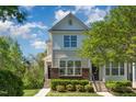 Beautiful two-story townhome with lush landscaping and a serene setting, capturing the essence of comfortable living at 162 Grey Elm Trl, Durham, NC 27713
