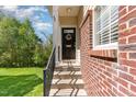 Inviting front entry with brick accents and decorative wreath, leading to a warm and welcoming home at 162 Grey Elm Trl, Durham, NC 27713