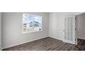 Well-lit bedroom featuring wood-look floors and a door leading to another room at 189 Calebs Corner Pl, Spring Lake, NC 28390