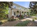 Charming home featuring a welcoming porch, swing, and meticulous landscaping at 205 W Moore St, Apex, NC 27502