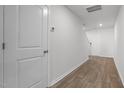 Clean, white entryway with wood-look flooring, leading to the rest of the home at 230 Bay Laurel Dr, Sanford, NC 27330