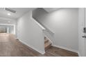 Bright entryway featuring wood-look flooring and a carpeted staircase to the upper level at 230 Bay Laurel Dr, Sanford, NC 27330