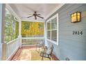 Cozy front porch with a ceiling fan, chairs, a rug, and an exterior light at 2814 Sarah Ave, Durham, NC 27707