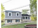 Charming home featuring brick and light gray siding, black shutters, and a well-maintained front yard at 2824 Wyncote Drive, Raleigh, NC 27603