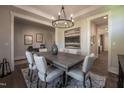 Spacious dining room features neutral walls, hardwood floors, modern chandelier, and modern decor at 306 White Magnolia Ln, Fuquay Varina, NC 27526