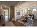 Bright dining room area features hardwood floors, modern chandelier, and access to other living areas at 306 White Magnolia Ln, Fuquay Varina, NC 27526