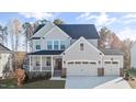 Beautiful two story home features a two car garage, covered porch, and professionally landscaped yard at 306 White Magnolia Ln, Fuquay Varina, NC 27526