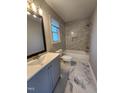 Renovated bathroom with marble tile, a soaking tub, and modern fixtures at 3109 Cinnamon Circle Cir, Raleigh, NC 27610