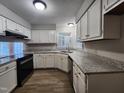 Updated kitchen with stainless steel appliances, granite countertops, and hardwood flooring at 3109 Cinnamon Circle Cir, Raleigh, NC 27610