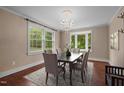 Elegant dining room featuring a chandelier, hardwood floors, and natural light from the windows at 323 Coral Ave, Goldston, NC 27252