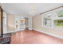 Bright living room featuring hardwood floors, a decorative chandelier, and glass doors leading to other rooms at 323 Coral Ave, Goldston, NC 27252