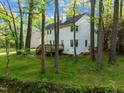 Spacious backyard with mature trees and a wooden deck perfect for outdoor entertaining at 3514 Shady Creek Dr, Durham, NC 27713
