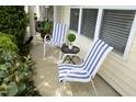 Charming front porch with striped chairs and well manicured shrubs at 3623 Bison Hill Ln, Raleigh, NC 27604