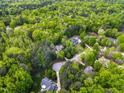 An aerial view showing the neighborhood and lush surrounding greenery at 40 Holden Ct, Youngsville, NC 27596