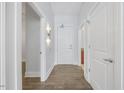 Hallway with wood floor, white walls, and multiple doors leading to other rooms at 400 W North St # 502, Raleigh, NC 27603