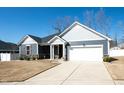 Attractive single-story home with gray siding, stone veneer, a two-car garage, and an inviting entrance at 403 Lagoon Ln, Mebane, NC 27302