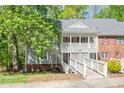 Charming condo featuring a covered entryway with white railing and a well-maintained yard at 407 Gooseneck Dr # A2, Cary, NC 27513