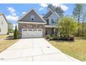 Charming two-story home with stone accents, well-manicured lawn, and attached two-car garage at 421 Long Lake Dr, Fuquay Varina, NC 27526