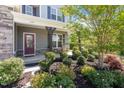Inviting front porch featuring a cozy seating area and well-maintained landscaping at 421 Long Lake Dr, Fuquay Varina, NC 27526