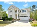 Beautiful two-story home with a two-car garage and a spacious driveway and well manicured lawn at 44 S Wilders Ridge Way, Clayton, NC 27527