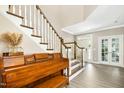 Elegant foyer showcasing hardwood floors, a staircase with white balusters and a wood railing at 44 S Wilders Ridge Way, Clayton, NC 27527
