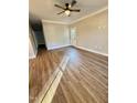 A spacious living room featuring natural light, modern hardwood flooring, and a ceiling fan at 50 Lakewood Dr, Roxboro, NC 27573