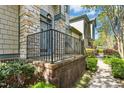 Inviting front porch with brick and stone accents, black metal railing, and manicured landscaping at 507 Presque Isle Ln # Bldg 500, Chapel Hill, NC 27514