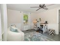 Office/bedroom with natural light, ceiling fan and modern desk area, ideal for work or relaxation at 509 N Elm St, Benson, NC 27504