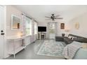 Bright living room with large windows, ceiling fan, and cozy seating area with a sectional sofa at 509 N Elm St, Benson, NC 27504