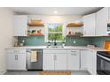 Well-lit kitchen showcases white cabinets, quartz countertops, and a sleek backsplash at 513 Hugo St, Durham, NC 27704