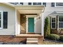 Close up of the front door with stone detail and a bright teal color that pops at 601 E Dynasty Dr, Cary, NC 27513