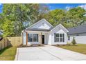 Charming new construction home with white siding, black shutters, and well-manicured lawn at 617 Ray St, Selma, NC 27576